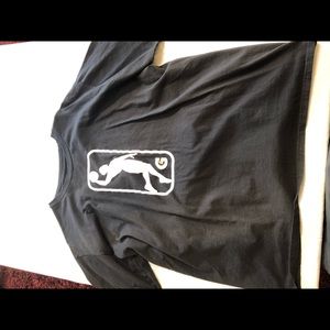Black cotton NBA G-League short sleeved shirt.